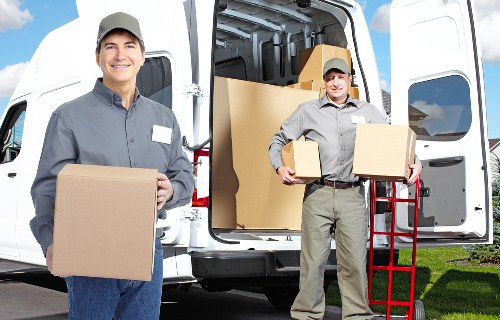 Professional movers loading items into a removal van